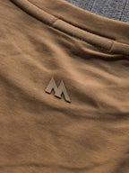 Close-up of a brown fabric with a logo on a textured surface